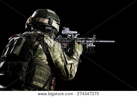 Fighter Of A Special Unit Is Aiming At The Sight Of The Machine Gun. Mixed Media