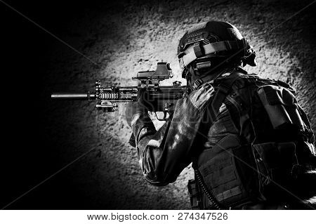 Fighter Of A Special Unit Is Aiming At The Sight Of The Machine Gun. Mixed Media