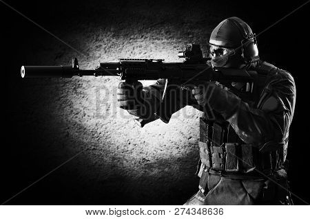 Fighter Of A Special Unit Is Aiming At The Sight Of The Machine Gun. Mixed Media