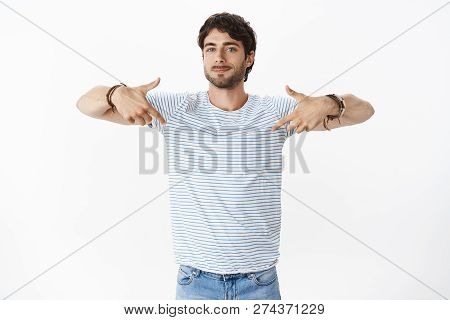 Self-assured Masculine And Happy Young European Handsome Man With Bristle, Big Blue Eyes And Wavy Sh