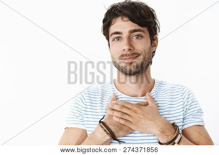 Waist-up Shot Of Happy And Touched Young Good-looking Male With Blue Eyes And Bristle Holding Hands 