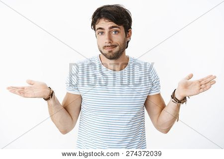 Nothing You Can Do. Portrait Of Uninvolved Careless Handsome Guy Swipe Hands Sideways Pursing Lips A