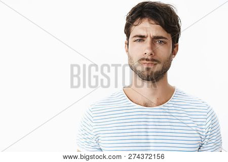 Guy Looking Frustrated And Disappointed Squinting Feeling Doubtful, Unsure And Suspicious Standing C