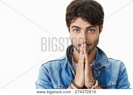 Close-up Shot Of Worried Good-looking Mature Guy With Beard And Blue Eyes Feeling Concerned Holding 