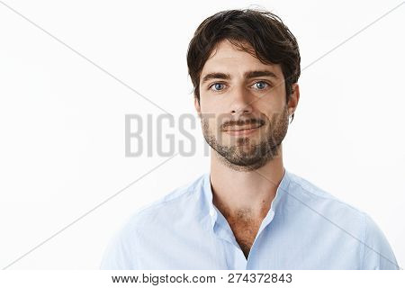Close-up Shot Of Pleased Attractive Mature Guy With Beard And Blue Eyes In Shirt With Unbuttoned Col