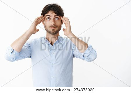 Waist-up Shot Of Thoughtful Good-looking Male Employee In Shirt Holding Hands On Temples As Looking 