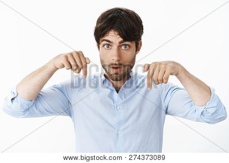 You Better Look Where I Point. Persuasive Intense And Serious Good-looking Hispanic Male With Beard 