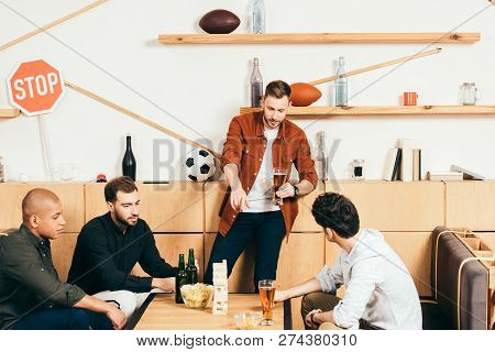 Multiethnic Friends Playing Blocks Wood Game In Cafe