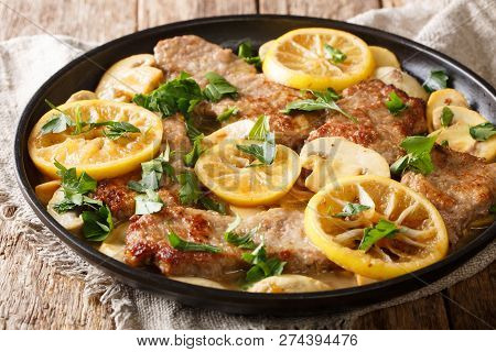 Italian Main Course Veal Scaloppini Cooked With Mushrooms And Lemons In A Spicy Sauce, Close-up. Hor