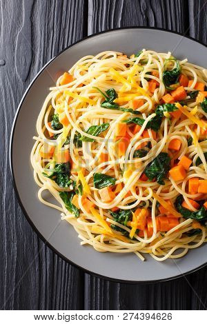 Organic Spaghetti Meal With Pumpkin, Spinach And Cheddar Cheese Close-up On A Plate. Vertical Top Vi