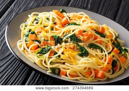 Organic Spaghetti Meal With Pumpkin, Spinach And Cheddar Cheese Close-up On A Plate. Horizontal