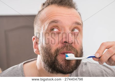 Funnny Guy Taking Care Of His Oral Hygiene, Brushing Teeth During Morning Bathroom Routine.