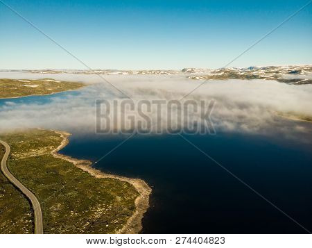 Aerial View. Road Crossing Hardangervidda Mountain Plateau, Clouds Over Lakes, Morning Time. Norway 