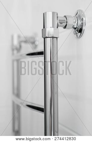 Close-up View Of Heated Towel Rail In Bathroom.