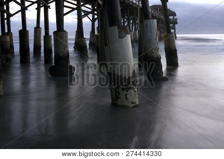 The Waves Flow Between The Pylons Of The Cocoa Beach Pier In Florida