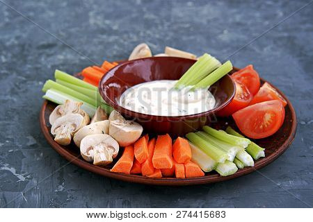Vegetable Tray With A Ranch Dip On A Dark Background. Raw Vegetable Mix Includes Sliced Mushrooms, C