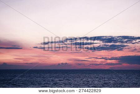 Gentle Pink Sunset Over Calm Water Surface
