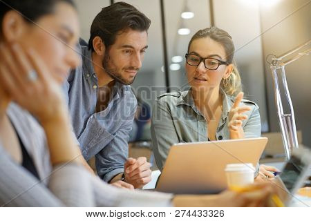 Colleagues workshopping business ideas in modern co working space