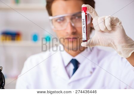 Young handsome lab assistant testing blood samples in hospital 