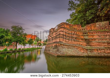 Chiang Mai, Thailand old city ancient wall and moat at dusk. 