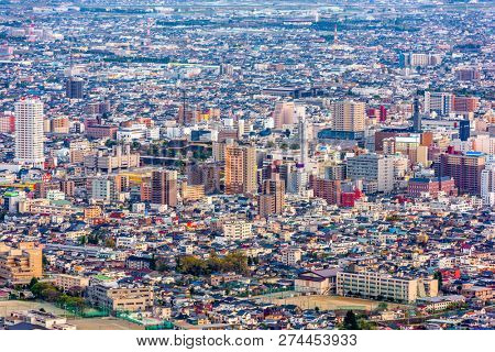 Kofu, Yamanashi, Japan downtown city skyline from the mountains at dusk.