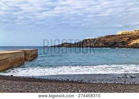 Stones pier at beach in Callao Salvaje on Tenerife, Spain