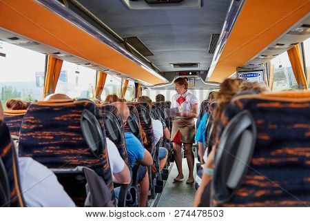 Marmaris, Turkey - May 26, 2018: Female Guide In The Bus With Tourists. People During Travel. Transf