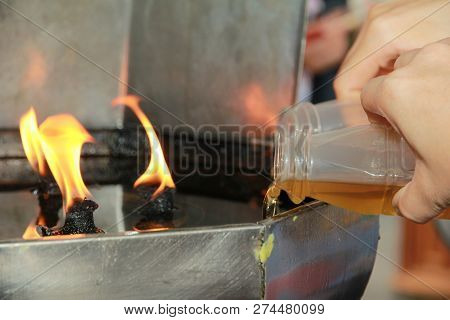 Buddhists Make Merit,oil Fill In A Lamp For Lighting And For Use In Incense. Means To Make Life Smoo