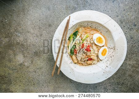 Japanese Ramen Noodle With Chicken, Shiitake Mushroms And Egg In White Bowl, Top View