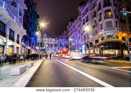 Madrid, Spain - December 15, 2018: Gran Via Avenue Illuminated At Christmas With Neon Lights And Tra