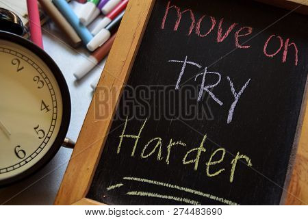 Move On Try Harder On Phrase Colorful Handwritten On Chalkboard, Alarm Clock With Motivation And Edu