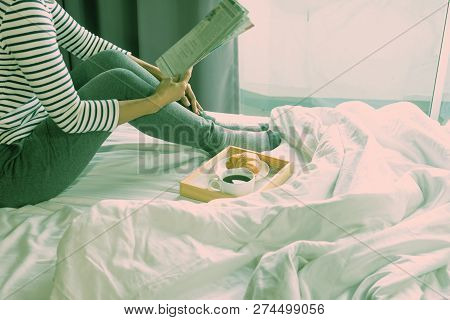 Relax Woman Read A Book On The Bed