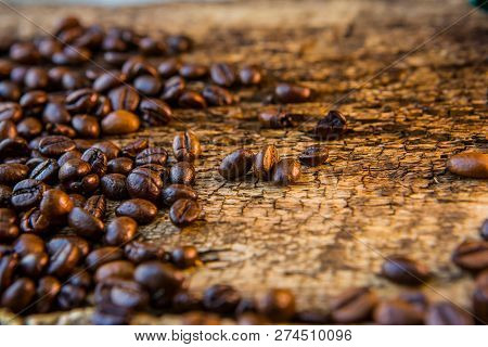 Coffee Beans On Wood Texture Background. Dark Background