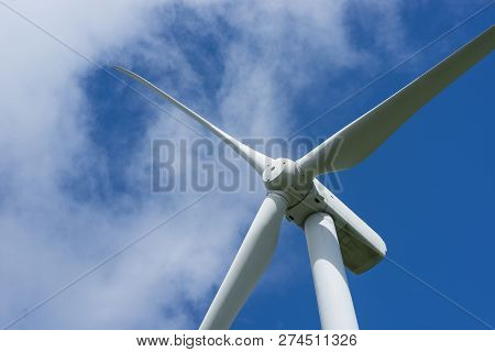 Ecology Concept: Blue Sky, White Clouds And Wind Turbine. Wind Generator For Electricity, Alternativ