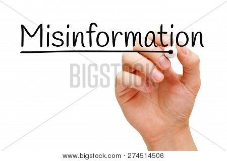 Hand Writing The Word Misinformation With Black Marker On Transparent Wipe Board Isolated On White.