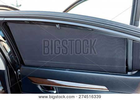 Sunblind On The Glass Of The Rear Door Of The Car Black Color Close-up Protects From The Sun Rays Te