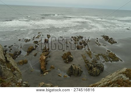 Remains Of Flysch Geological Formations On Los Quebrantos Beach On A Rain Day. July 30, 2015. Landsc