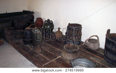 A Wooden Vat For Grape-stomping, Buckets And Other Antique Household Items In The Basement Of A Trad
