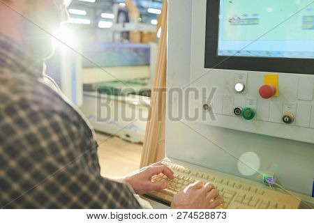 Close-up Of Busy Machine Operator Typing On Computer Keyboard While Working With Industrial Machine 