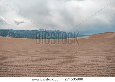 Layers Of Sand, Sand Texture, With Stormy Skies In Great Sand Dunes National Park In Colorado, Usa