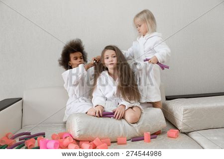 Little Girls Play With Hair Curlers And Hairpins.