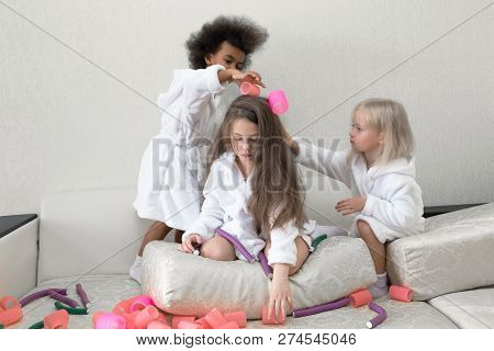 Little Girls Play With Hair Curlers And Hairpins.