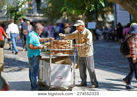 Greece, Athens - October 07, 2018 Donut Seller, Koulourakia, On The Street In Plaka District