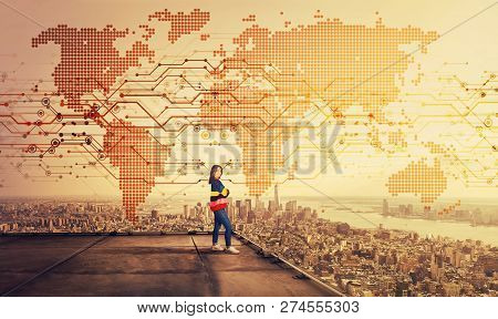 Confident Young Woman Standing With Crossed Arms On The Rooftop Of A Skyscraper Looking Over The Big