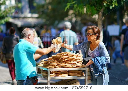 Greece, Athens - October 07, 2018 Donut Seller, Koulourakia, On The Street In Plaka District