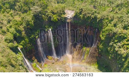 Aerial View Waterfall Coban Sewu In Java, Indonesia. Waterfall In Tropical Forest By Drone Tumpak Se
