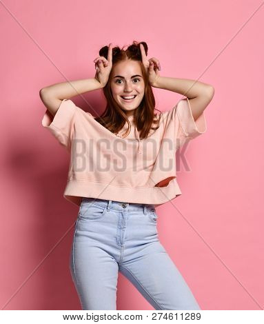 Smiling Young Crazzy Red Hair Woman Having Fun And Making Horns By Her Hands