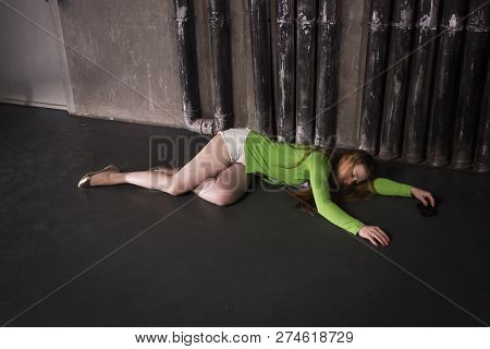 Lifeless Unconscious Woman Lying On A Factory Floor