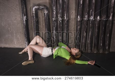 Lifeless Unconscious Woman Lying On A Factory Floor
