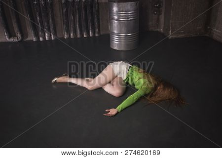 Lifeless Unconscious Woman Lying On A Factory Floor